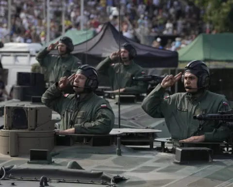 Poland showcases its growing army on a holiday that celebrates its historic defeat of the Red Army