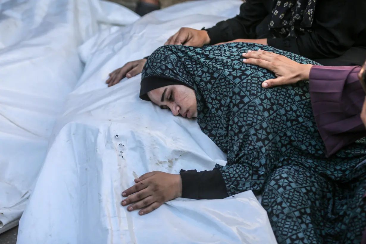 Relatives mourn over the bodies of Palestinian family members killed during an Israeli attack on Nuseirat refugee camp, after they were brought to Al-Aqsa Martyrs Hospital in Deir al-Balah, Gaza, on August 9.