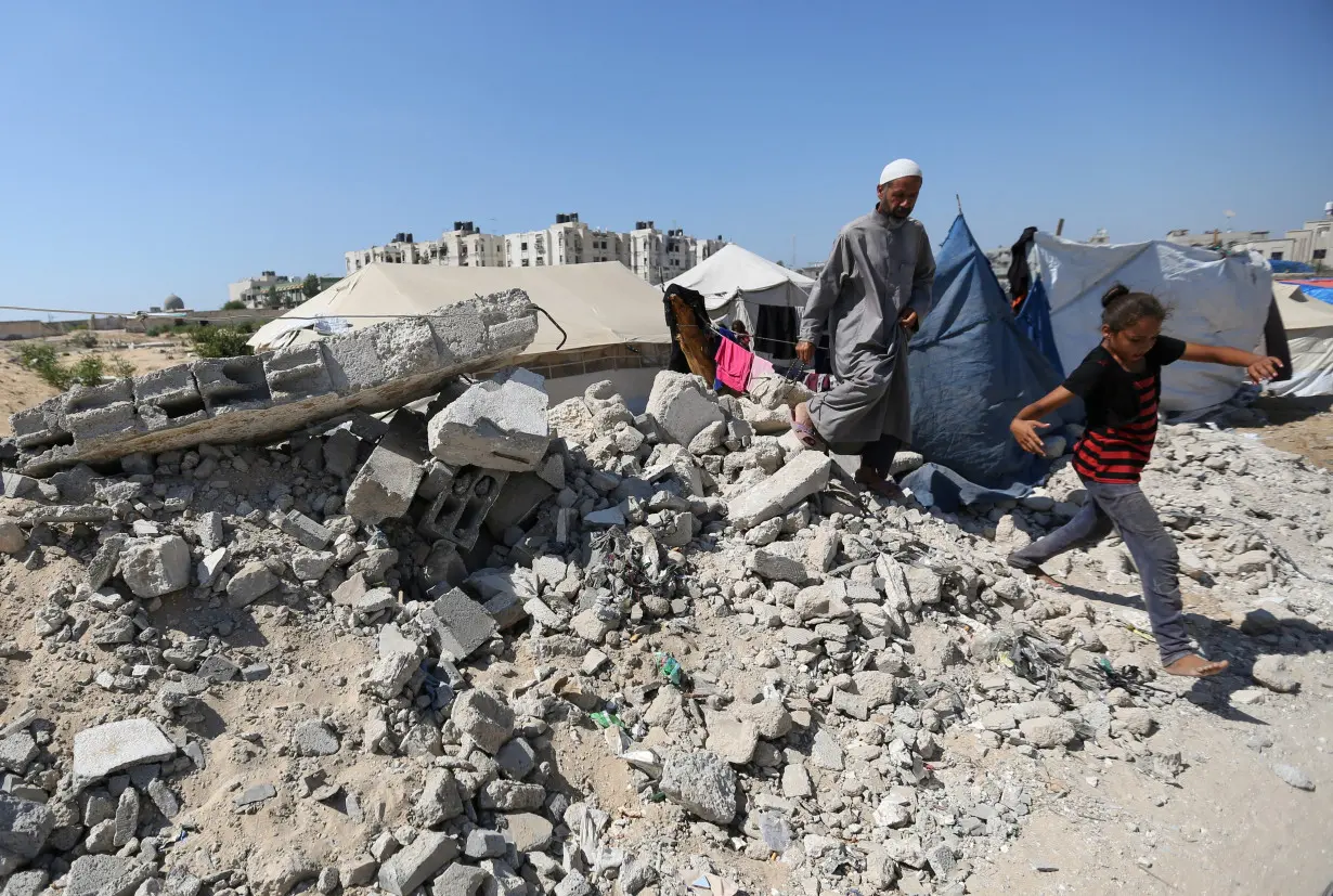 Displaced Palestinians shelter in a cemetery, as Gaza health ministry announced that death toll has surpassed 40,000