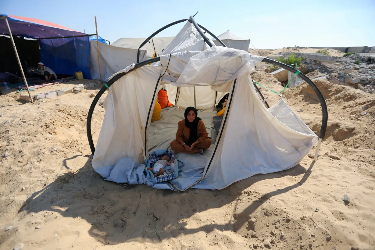 Displaced Palestinians shelter in a cemetery, as Gaza health ministry announced that death toll has surpassed 40,000