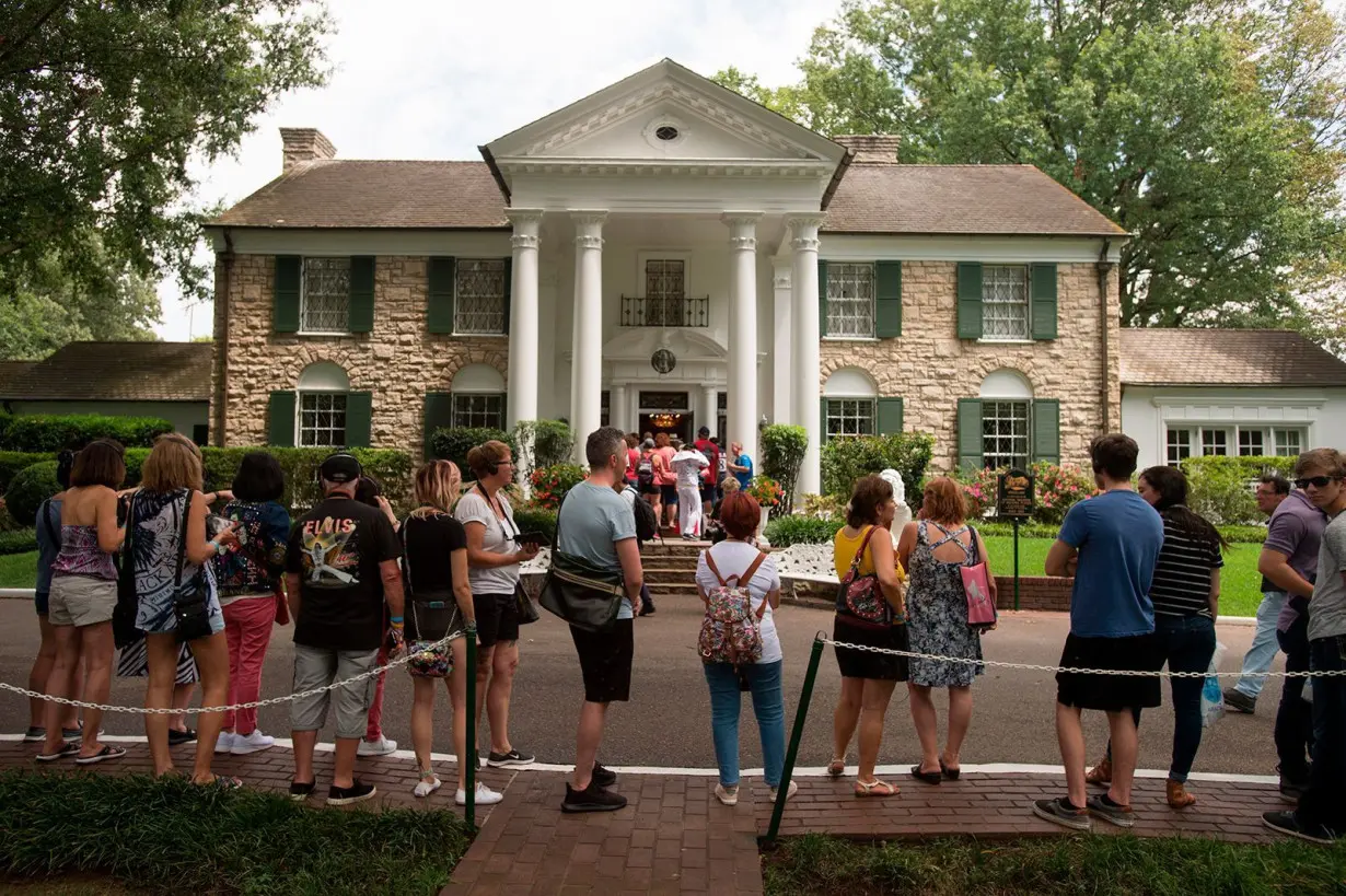 Fans wait in line outside Graceland, Elvis Presley's Memphis home, in August 2017.