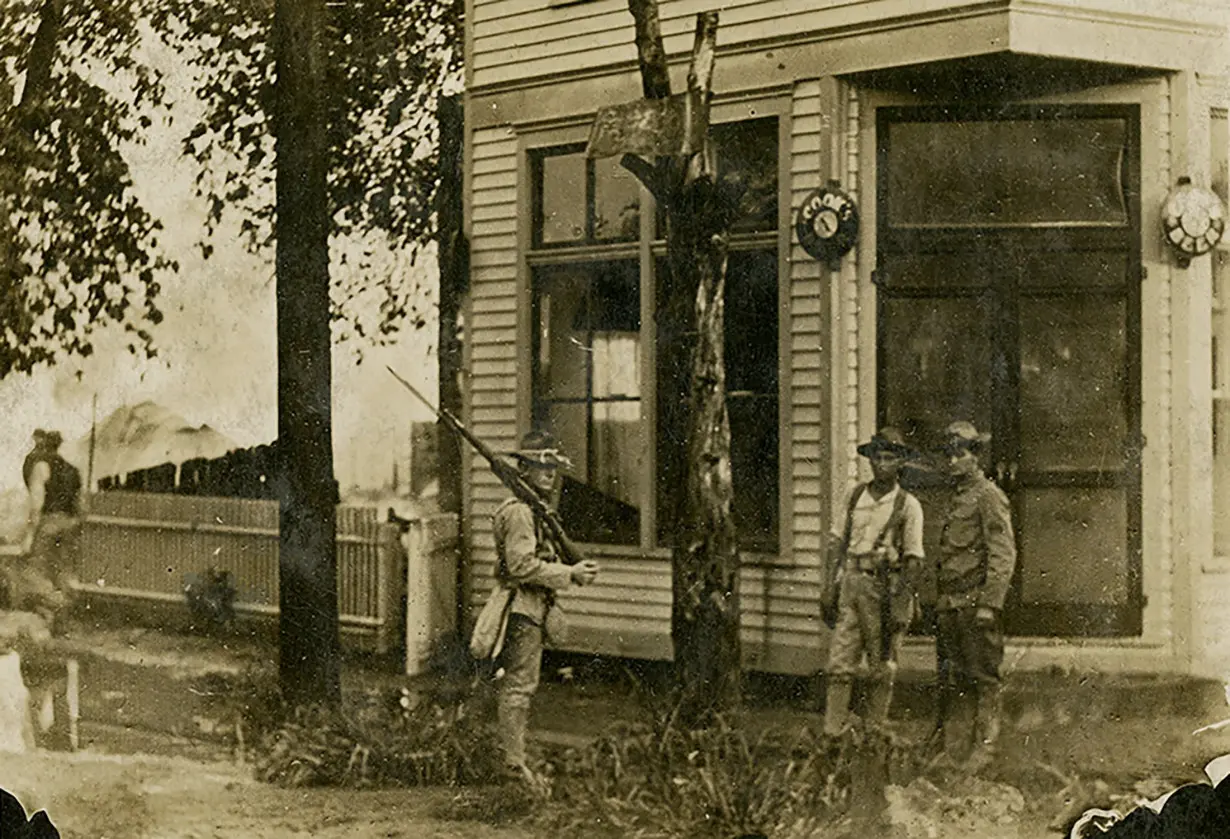 Troops stand guard after an August 1908 race riot in Springfield