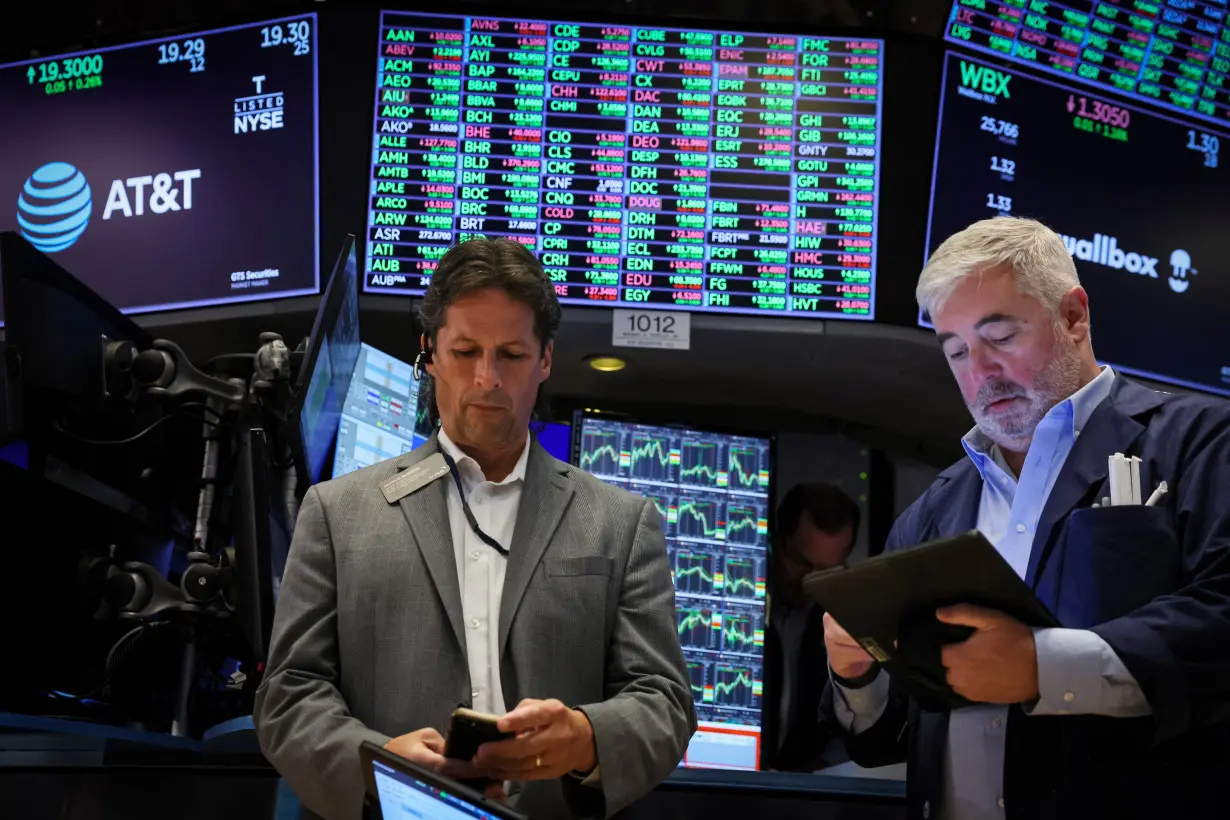 Traders work on the floor of the NYSE in New York