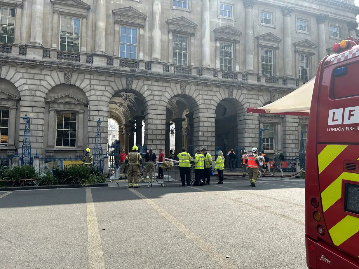 Firefighters outside Somerset House in central London. London Fire Brigade said: 