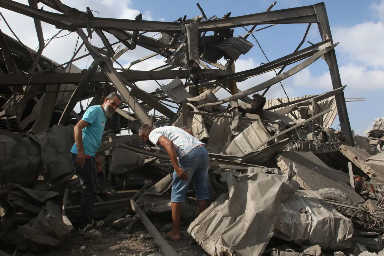 Men inspect the damage to a building after an Israeli strike in Nabatiyeh, Lebanon, on August 17.