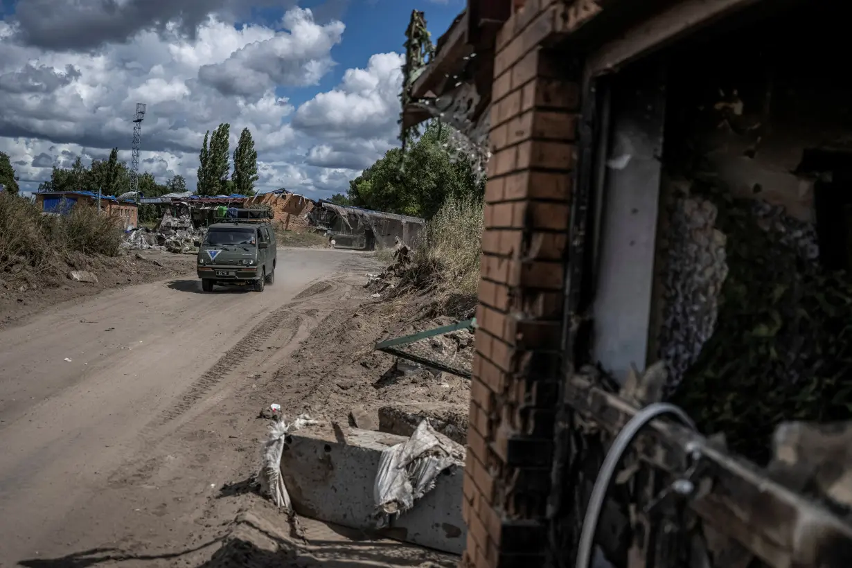 FILE PHOTO: Ukrainian soldiers ride a military vehicle near the Russian border in Sumy region