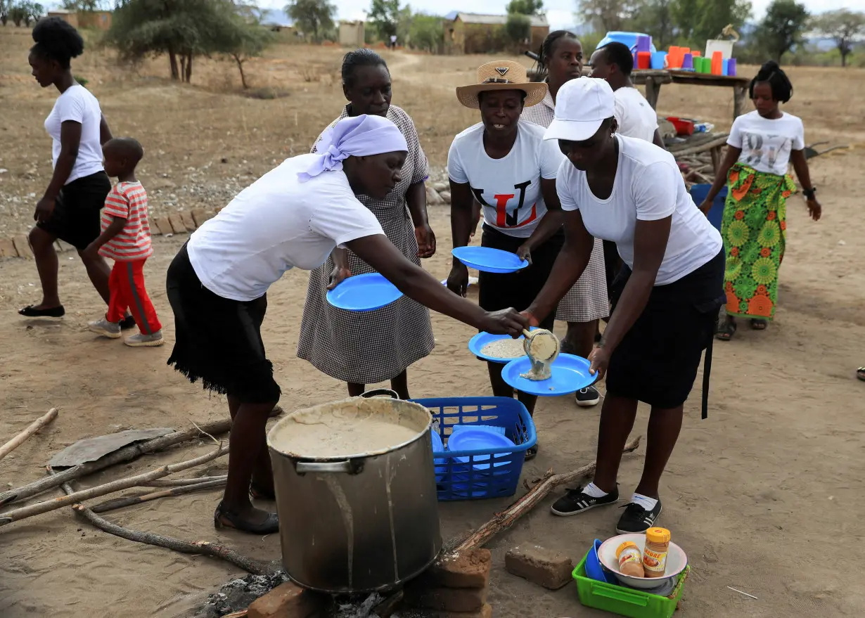 FILE PHOTO: A woman serves traditional porridge at a rural home, in Kotwa in Mudzi district