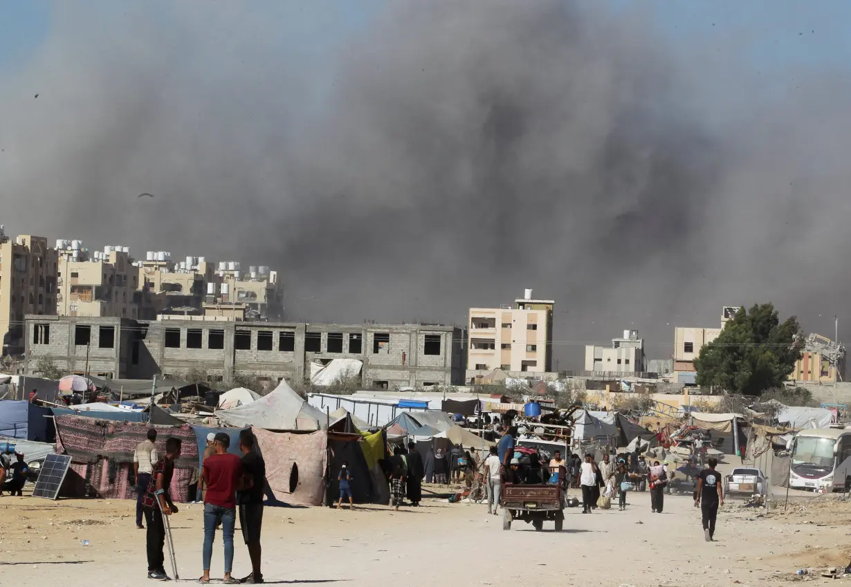 Smoke rises following an Israeli strike on a residential building, in Khan Younis