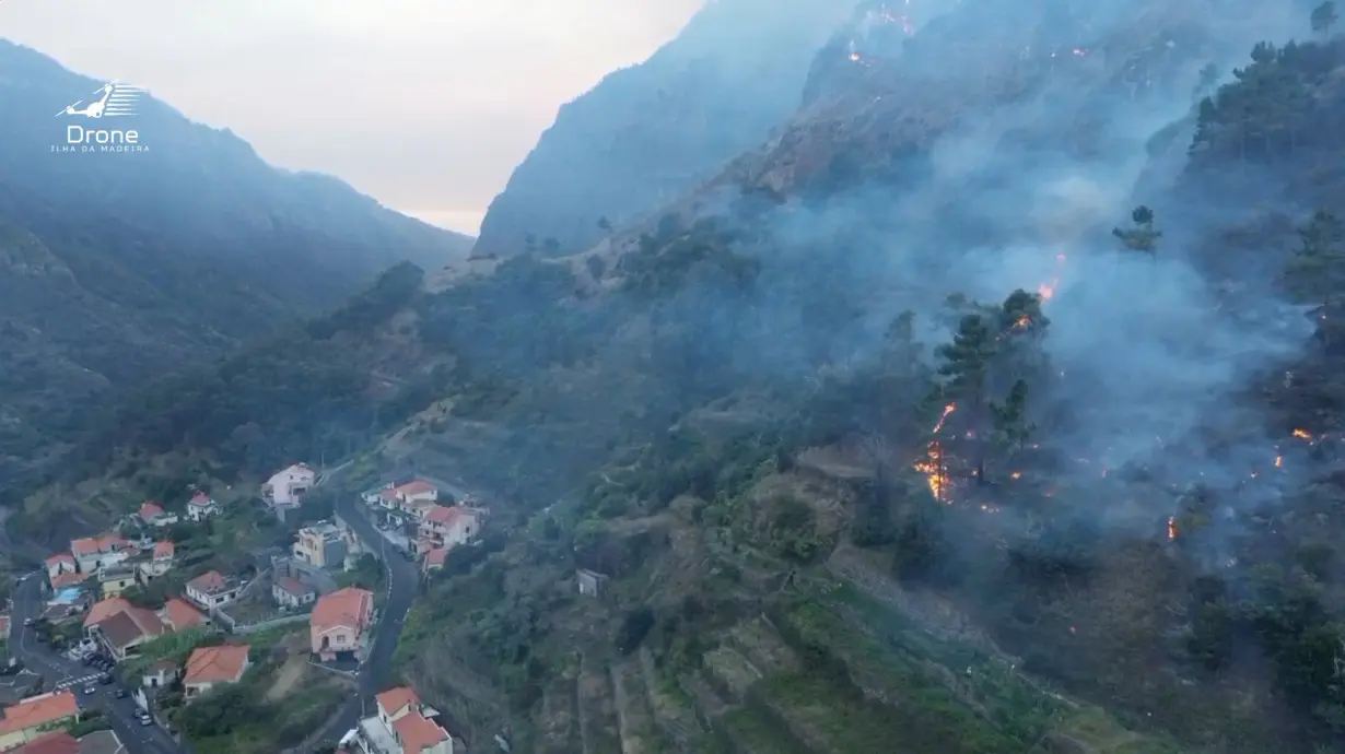 A drone view shows smoke rising as vegetation burns amid a wildfire in the municipality of Ribeira Brava