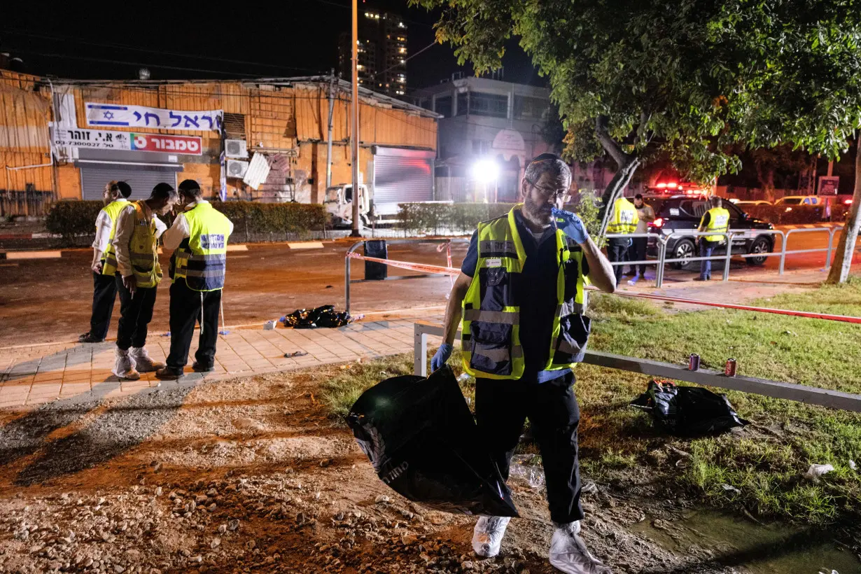 Emergency responders work at the site of a bomb blast in Tel Aviv