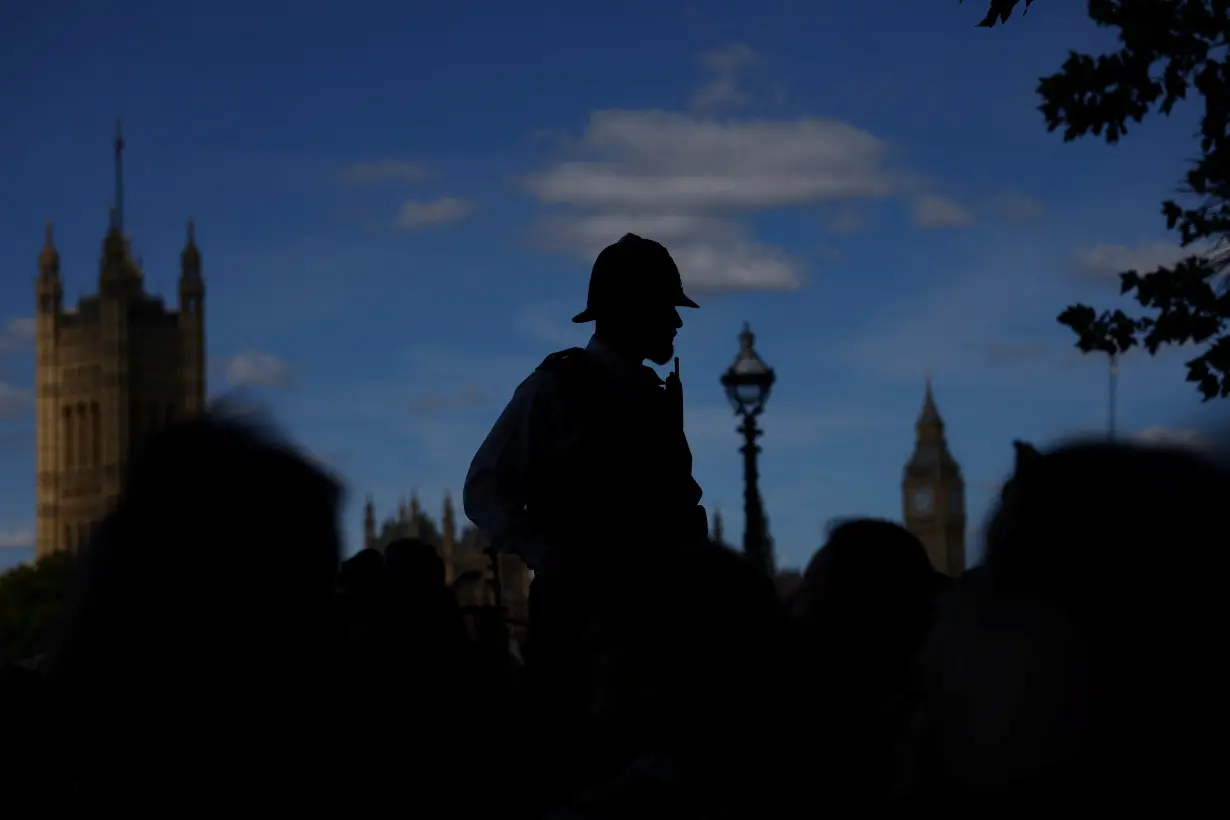 A police officer oversees the crowd in London, Britain