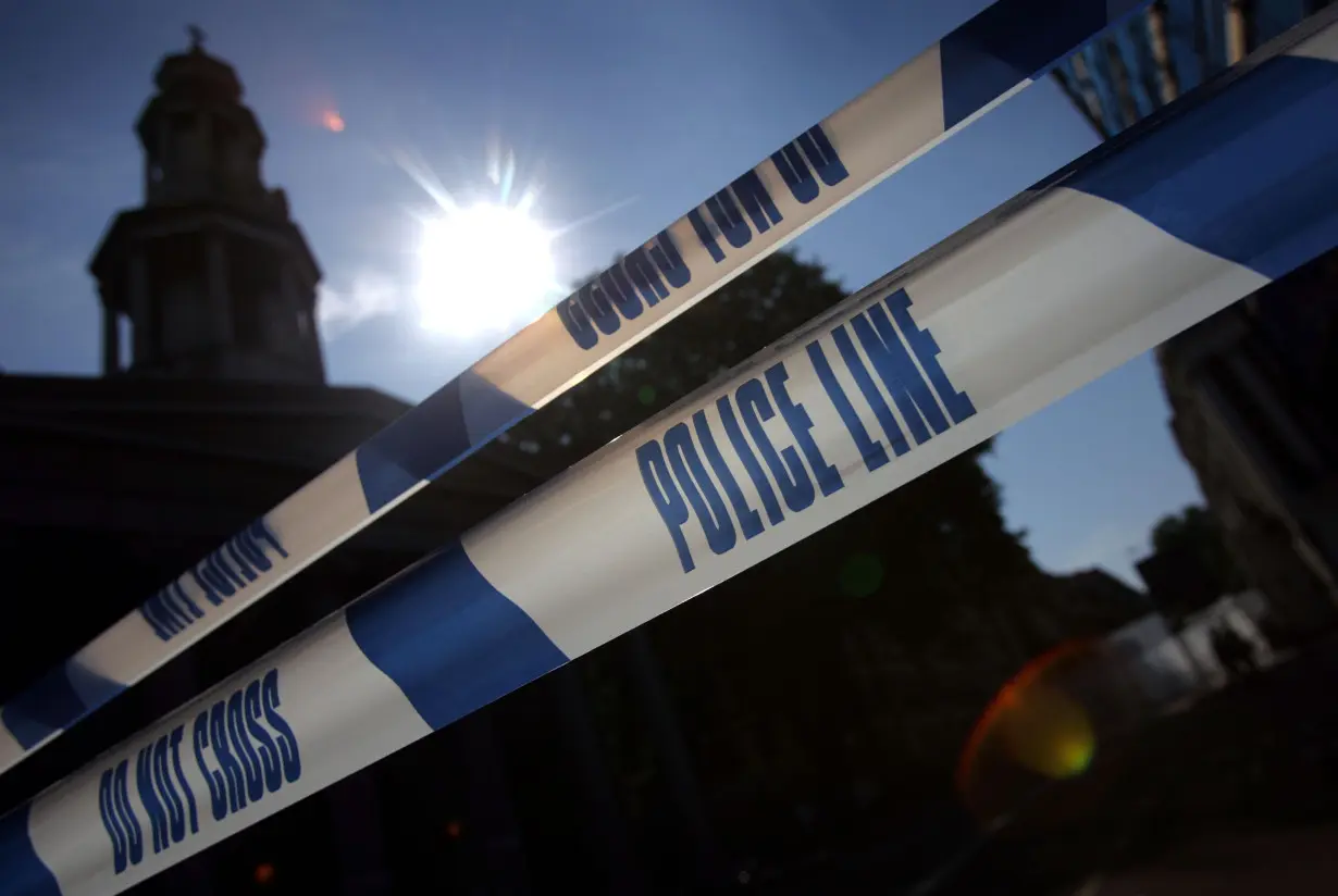 A police line seals off the area around the site where a bomb destroyed a bus on Thursday in Tavistock ...