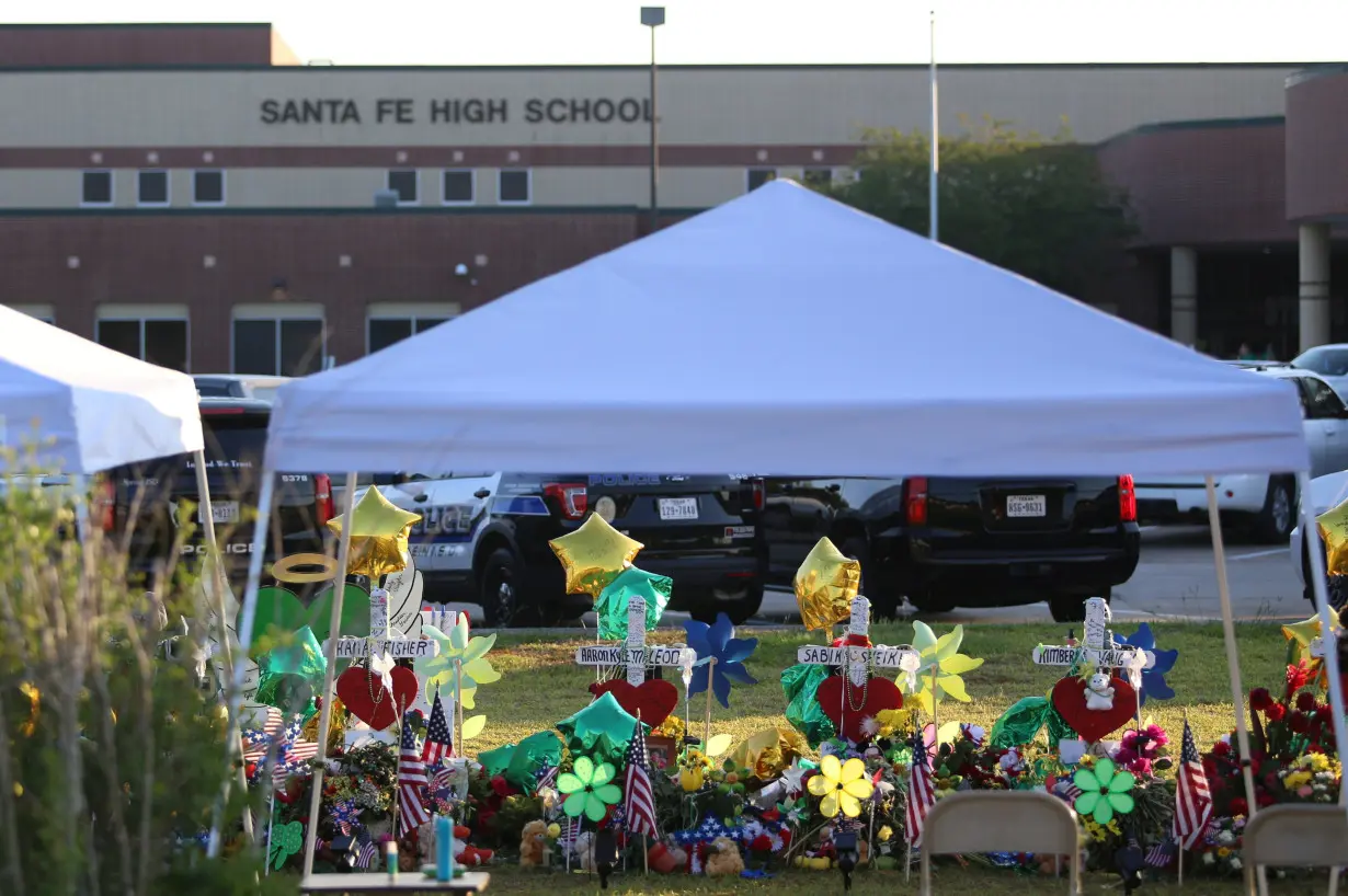 The memorial for victims of the Santa Fe High School shooting lays outside the school as students return on the first day of class