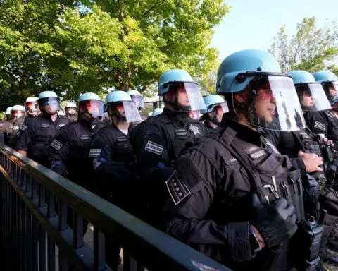 Some protesters tear down security fence as thousands march outside Democratic National Convention