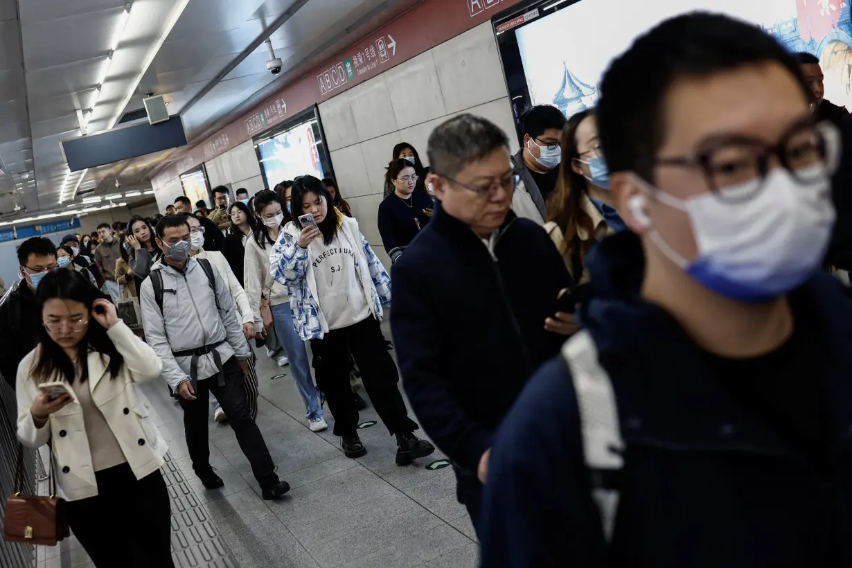 People walk at a subway station during morning rush hour in Beijing