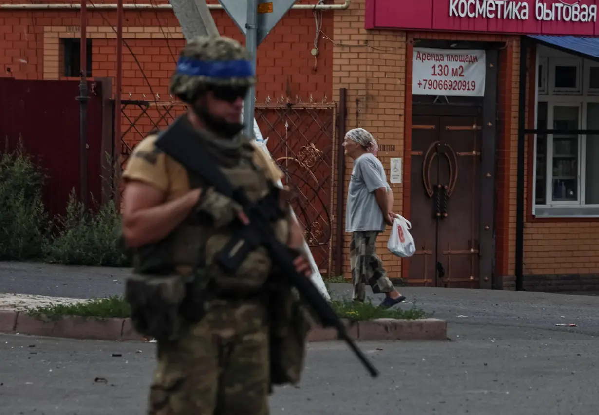 A Ukrainian serviceman patrols in the town of Sudzha