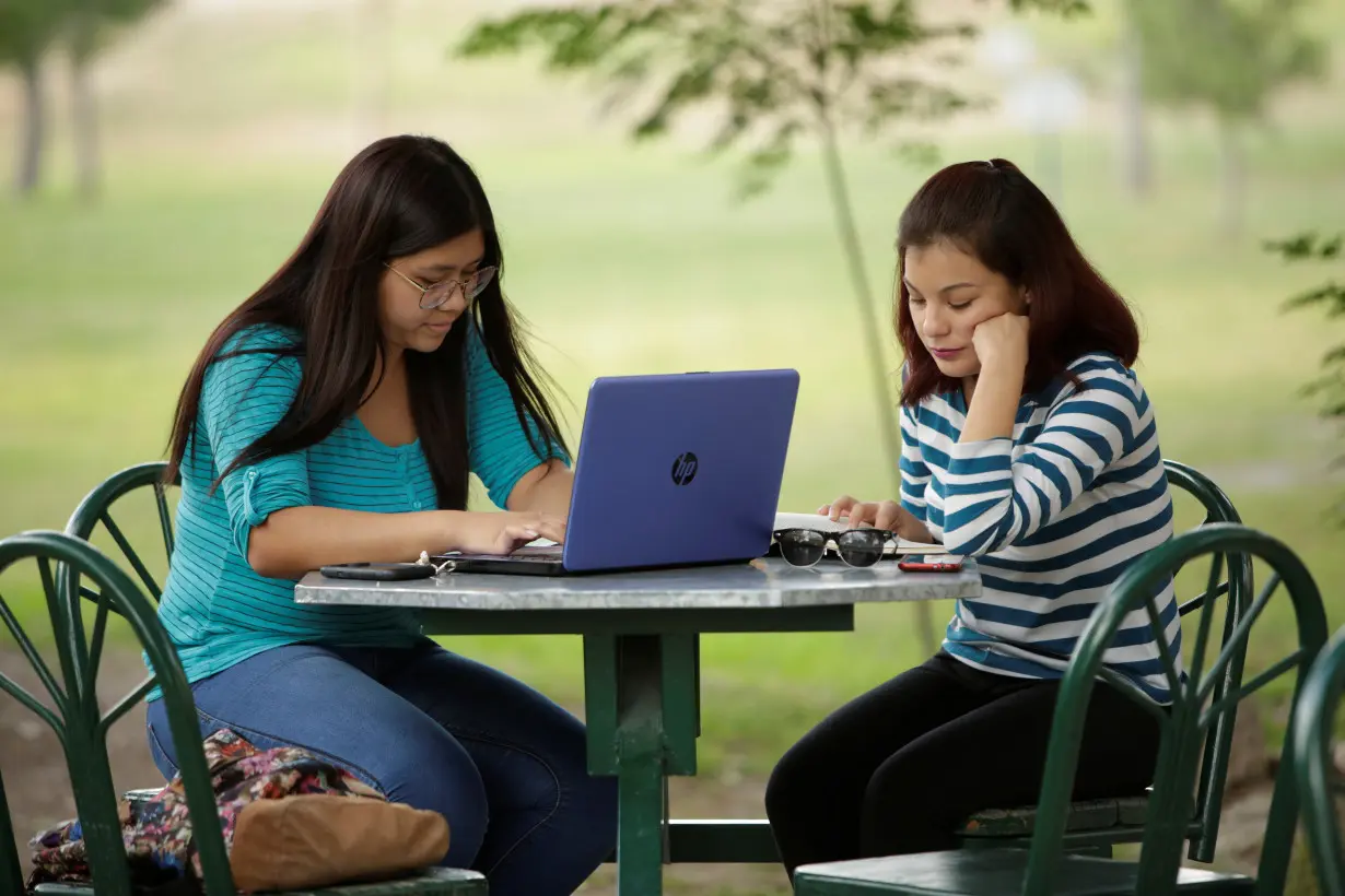 Woman works on her computer at a coffee shop in Ciudad Juarez