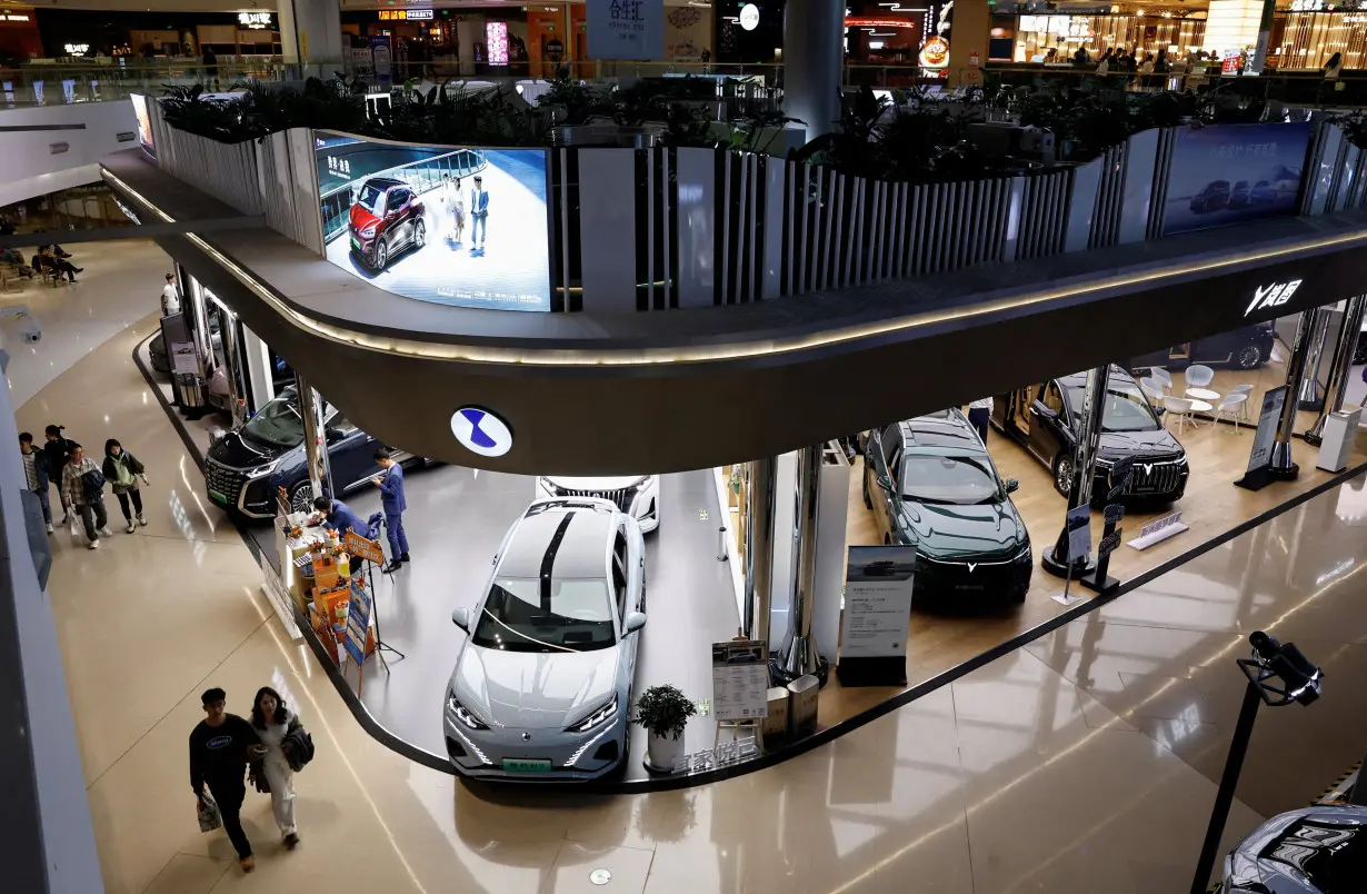 FILE PHOTO: Electric vehicle (EV) models are displayed at the booths of Denza and Chinese EV maker Voyah, at a shopping mall in Beijing