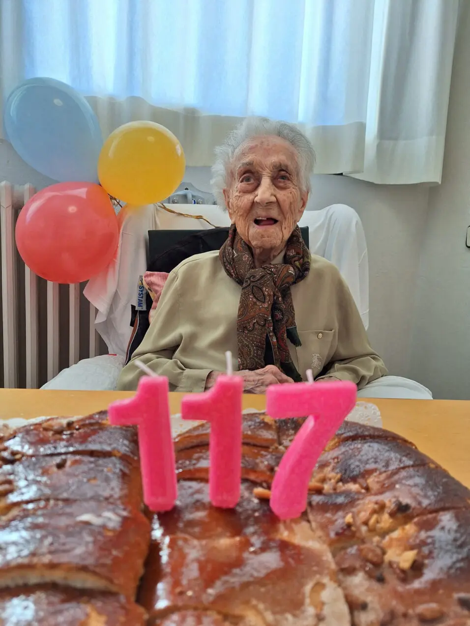 Maria Branyas, poses in front of a birthday cake as she celebrates her 117th birthday in a nursing home, in Girona