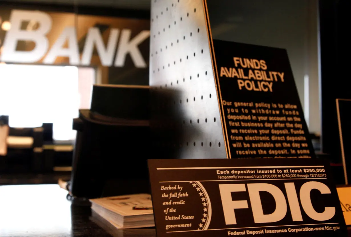 FILE PHOTO: Signs explaining Federal Deposit Insurance Corporation (FDIC) and other banking policies are shown on the counter of a bank in Westminster