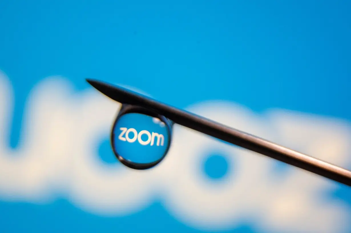 Zoom app logo is reflected in a drop on a syringe needle in this illustration photo