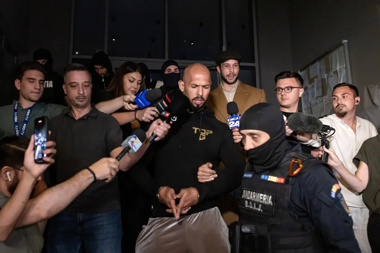 Andrew Tate and his brother Tristan are escorted outside the DIICOT in Bucharest