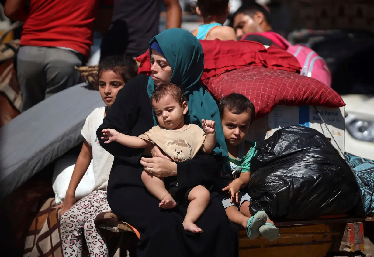 Palestinians flee with their belongings in Deir al-Balah, Gaza Strip, on August 21, 2024.