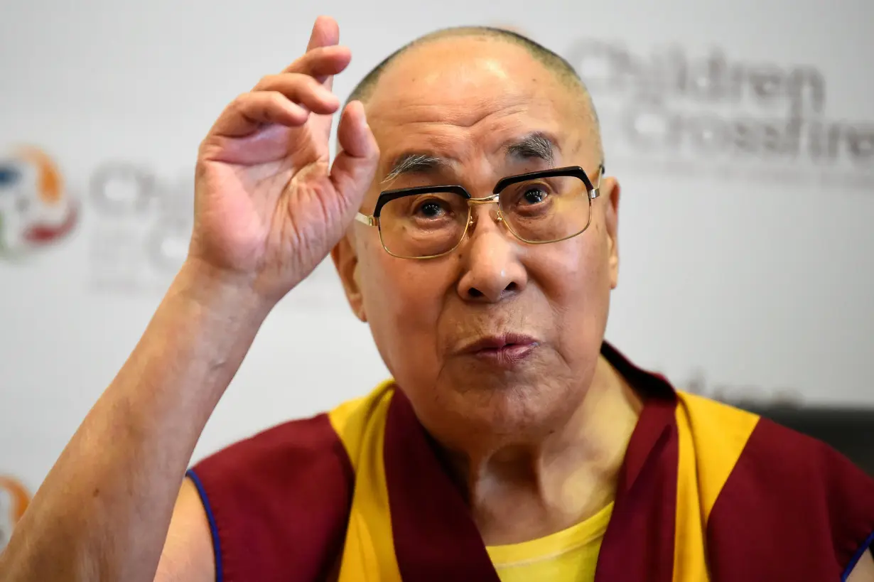 Tibetan spiritual leader the Dalai Lama, Patron of Children in Crossfire, gestures during a press conference in Londonderry