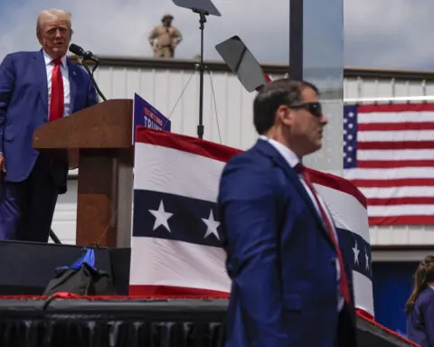 Trump speaks from behind bulletproof glass at first outdoor rally since his attempted assassination