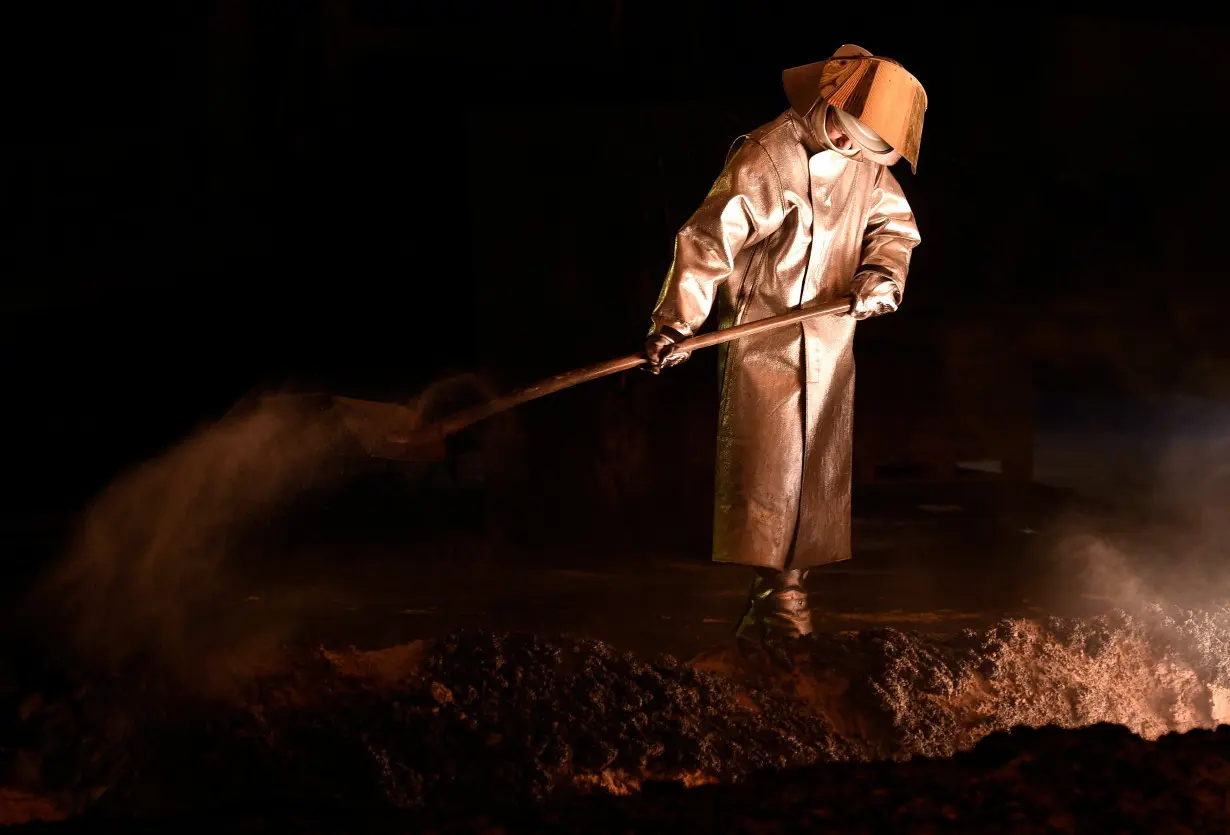 A steel-worker is pictured at a furnace at the plant of German steel company Salzgitter AG in Salzgitter, Lower Saxony