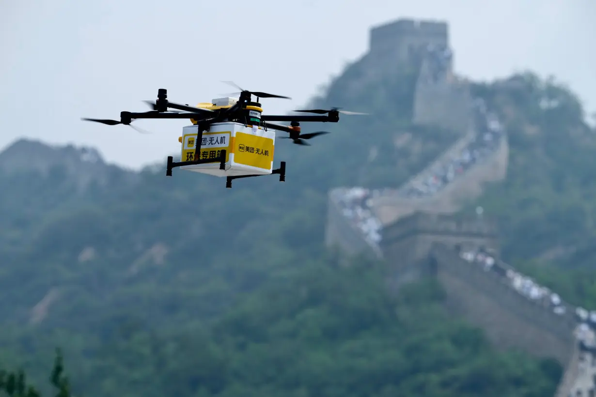 A drone carries a package from Chinese food delivery giant Meituan to the Badaling section of the Great Wall in Beijing, China, on August 16.