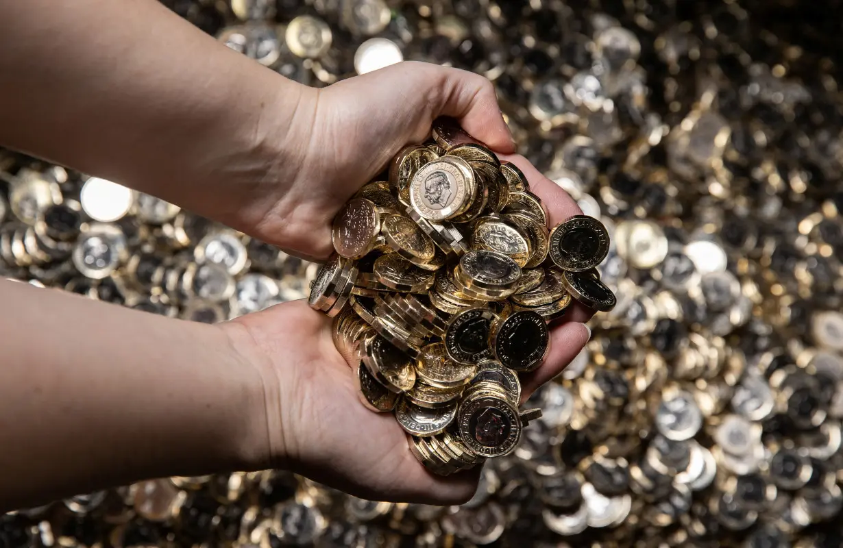 New pressings of the one pound coin are displayed at the Royal Mint in Llantrisant