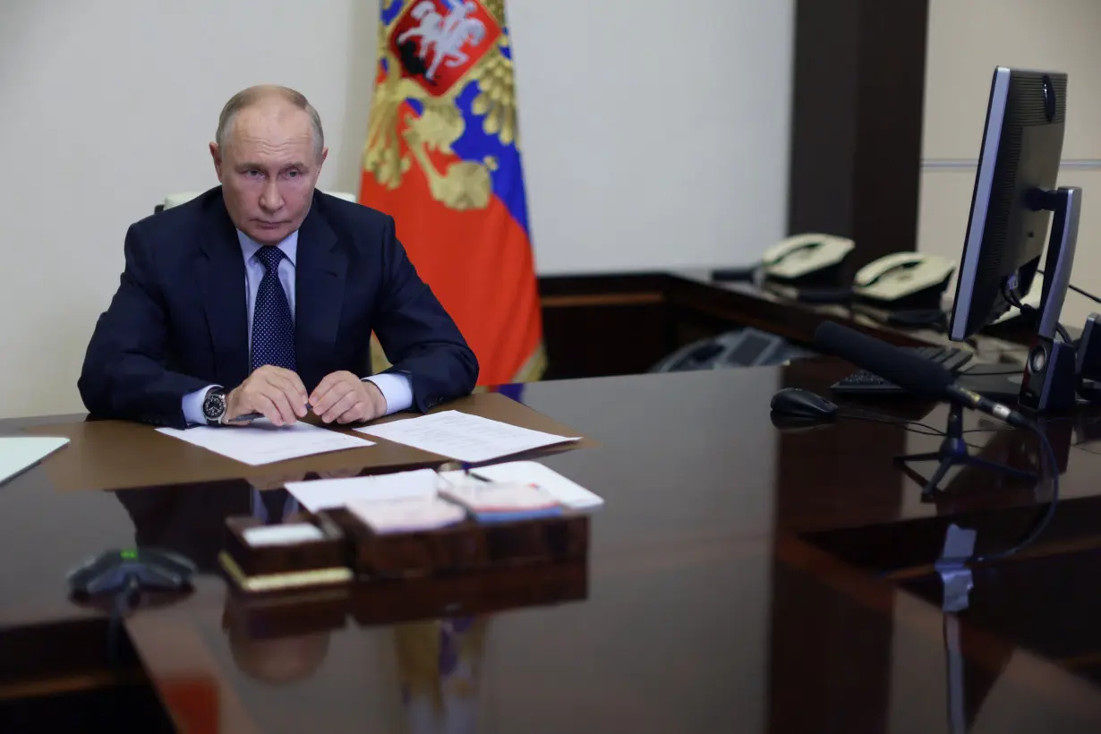 Russian President Putin chairs a meeting outside Moscow