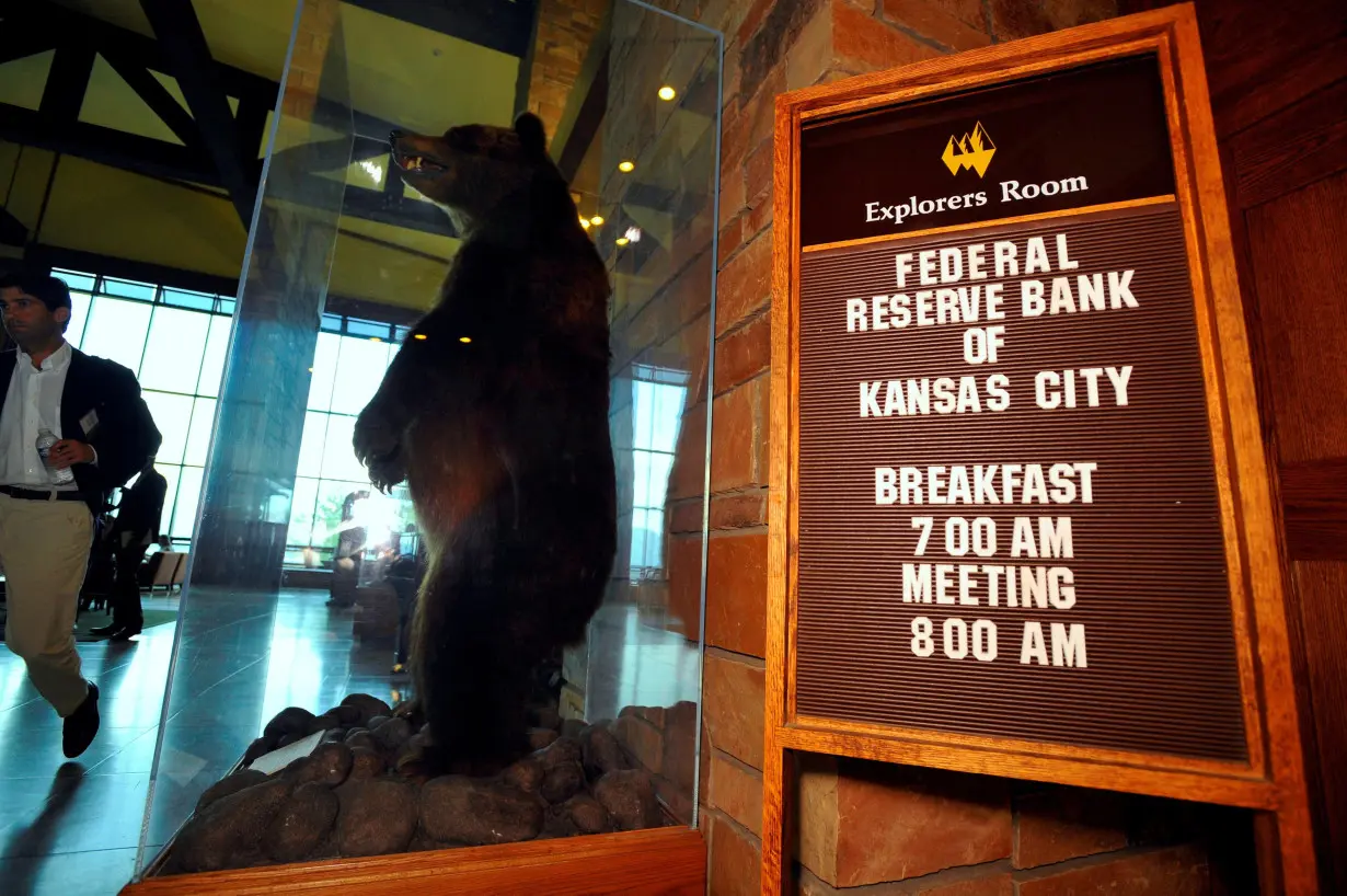 FILE PHOTO: A stuffed grizzly bear stands next to a sign in the lobby of Jackson Lake Lodge, the site of the Jackson Hole Economic Symposium in Grand Teton National Park