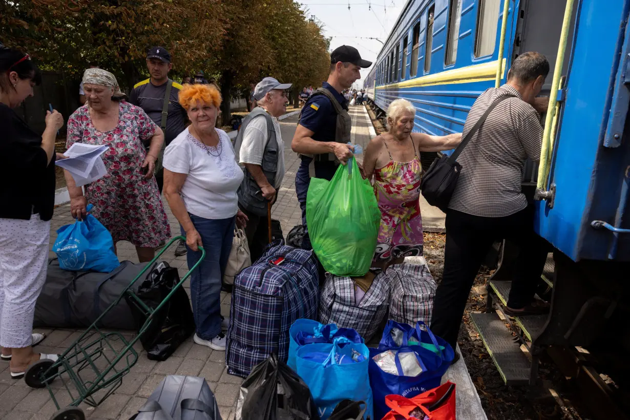 Local residents board an evacuation train as they flee Russian troop advances in Pokrovsk