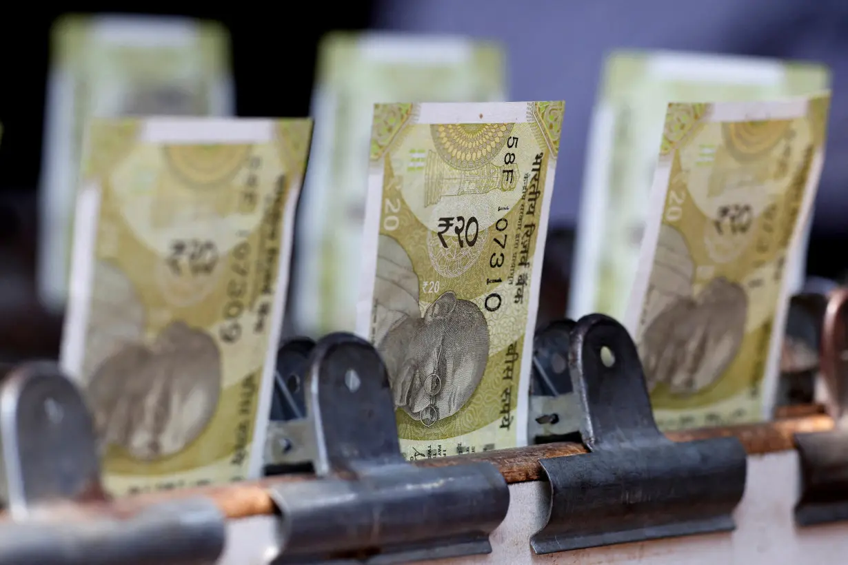 FILE PHOTO: Indian twenty rupee currency notes are displayed at a roadside currency exchange stall in New Delhi