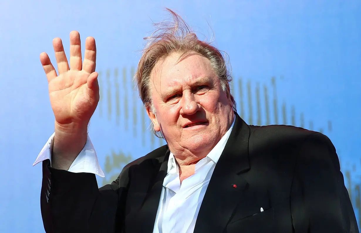 FILE PHOTO: Gerard Depardieu waves as he arrives during a red carpet event for the movie 