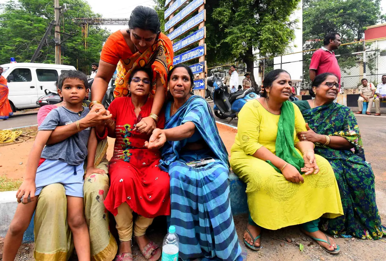 Relatives of the victims of a blast at the privately-held Escientia Advanced Sciences, mourn outside the King George Hospital mortuary in Visakhapatnam