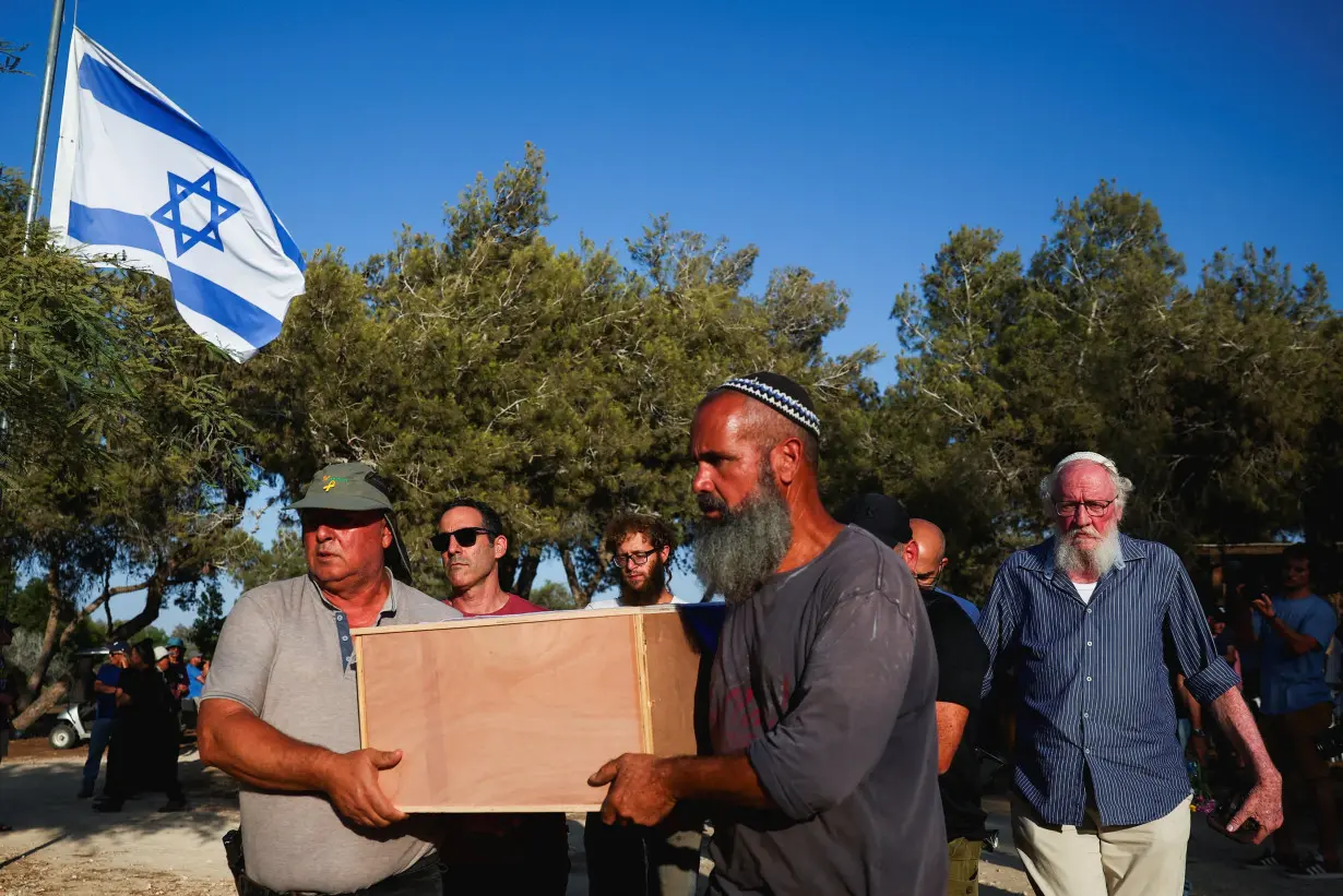 Mourners pay their respects to Yoram Metzger, at his funeral in Kibbutz Nir Oz