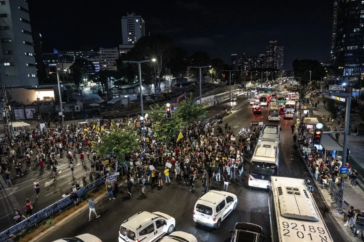 Israeli protesters holding banners and photos gather outside the defense ministry during a demonstration demanding ceasefire between Israel and Hamas and hostage swap deal in Tel Aviv, Israel on August 20, 2024.