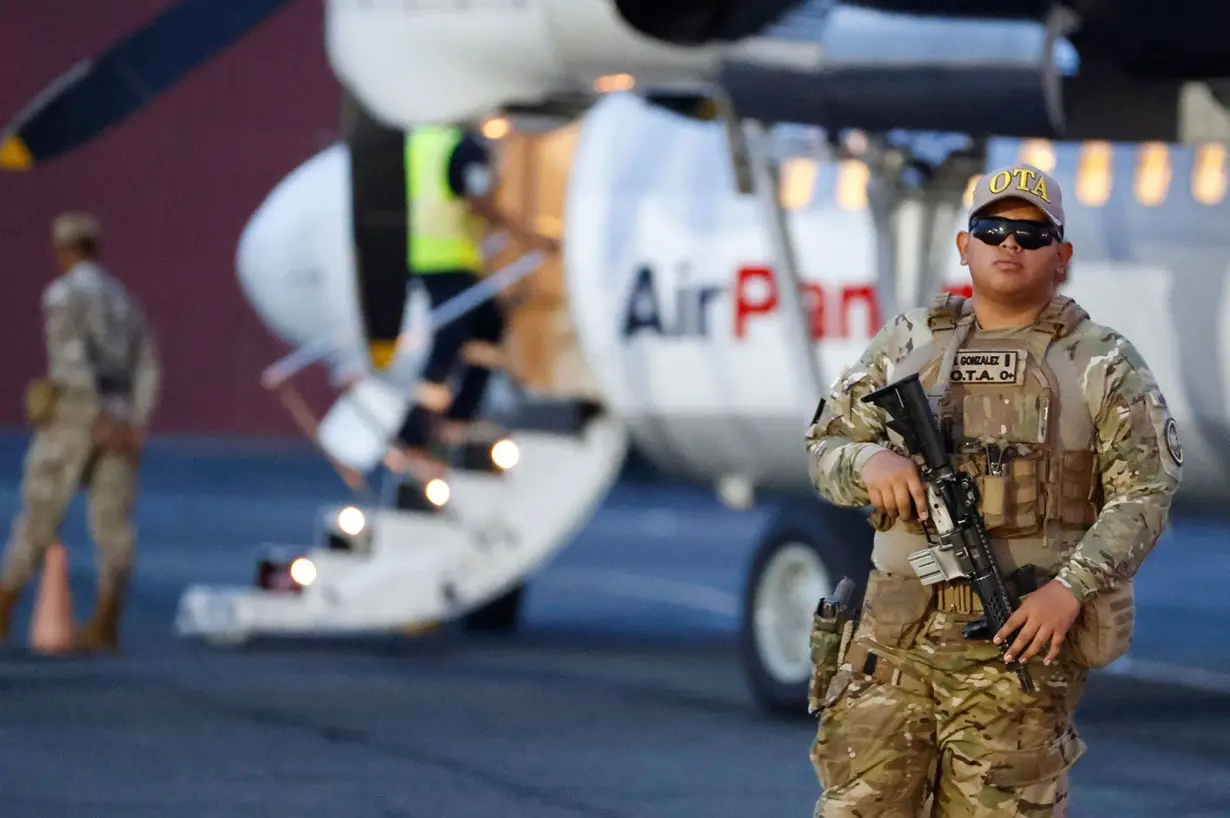 A member of the Tactical Aeronaval Operations (OTA) group monitors during a deportation process of migrants to Colombia at Albrook 'Marcos A. Gelabert' International Airport in Panama City, Panama, 20 August 2024.