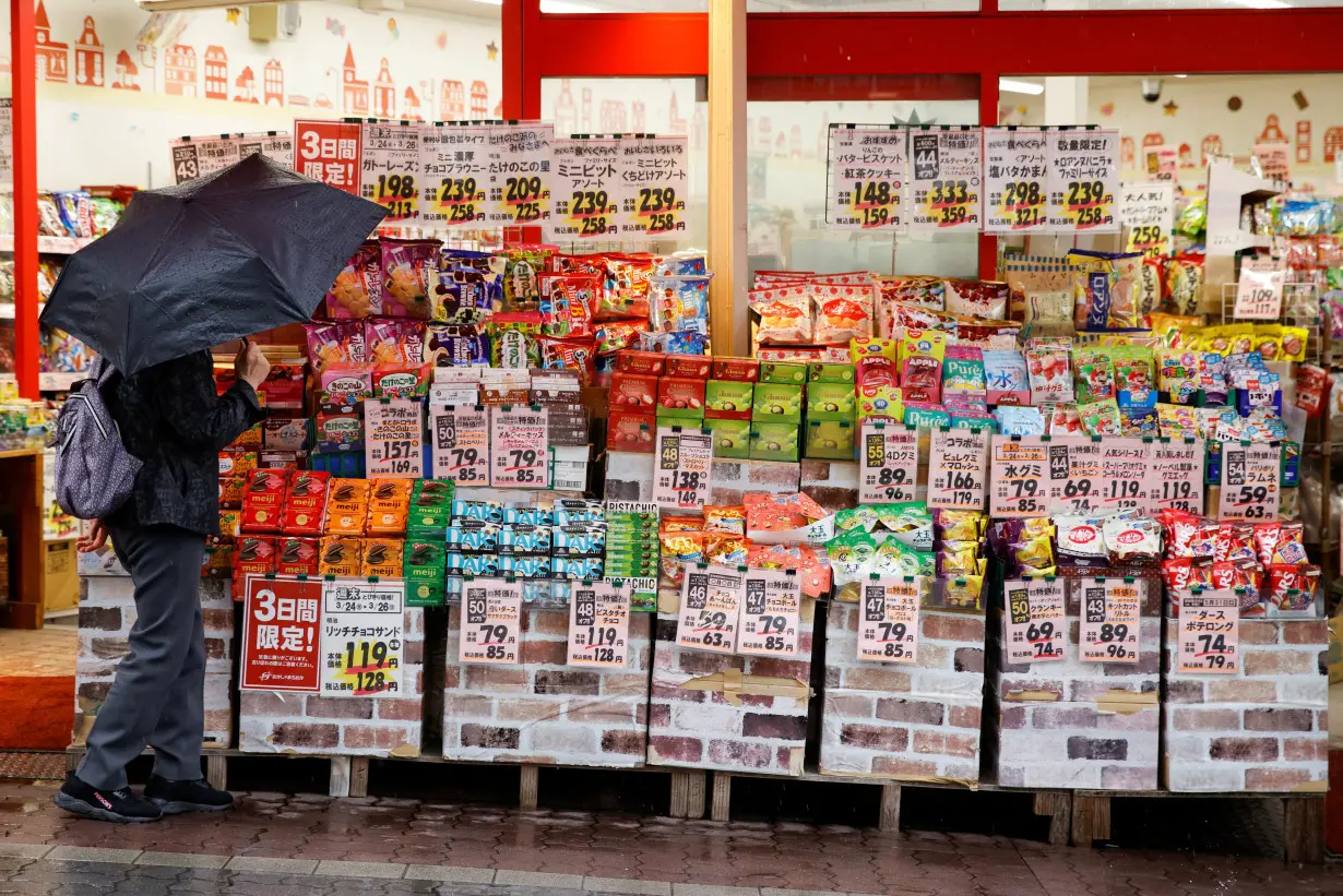 A woman looks at items at a shop in Tokyo