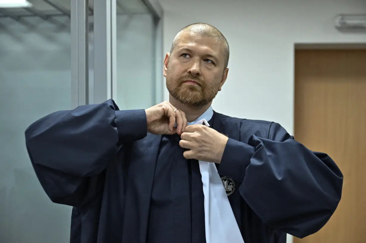 Judge Yevhen Zavhorodnyi prepares for work at a court hearing room in Zaporizhzhia