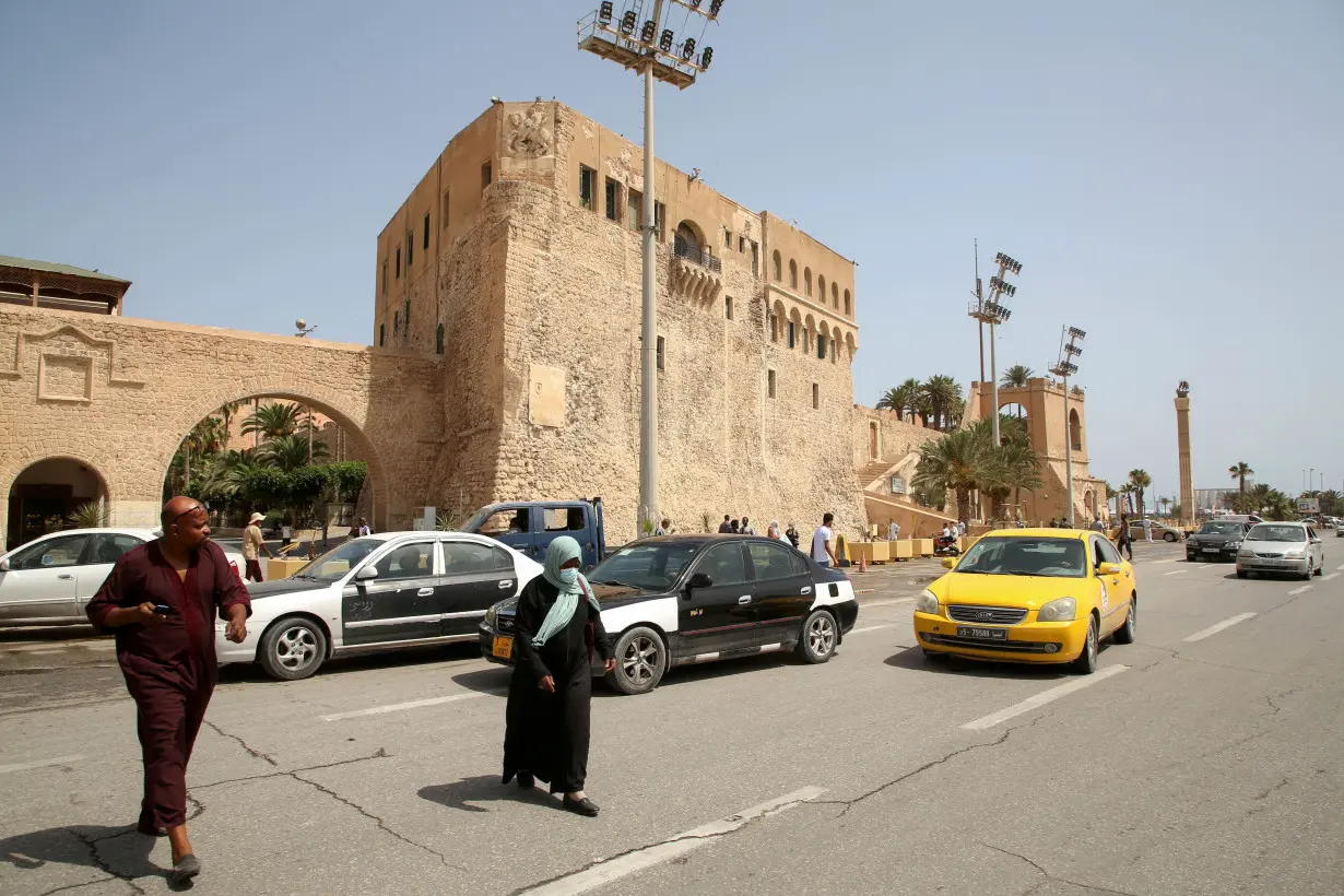 FILE PHOTO: People cross a street at Martyrs Square in Tripoli