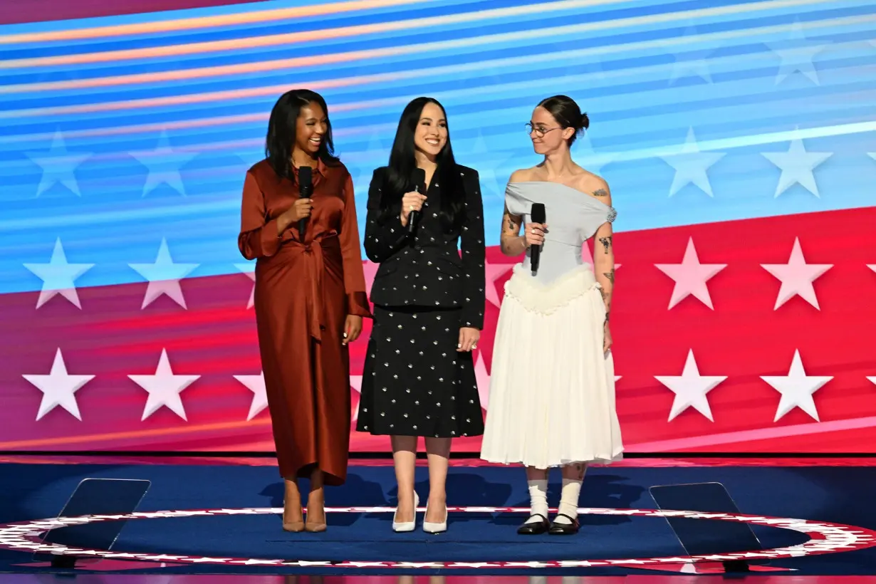 From left to right, Helena Hudlin, goddaughter of Kamala Harris and Meena Harris, Harris' niece stand alongside Emhoff to speak at the final day of the DNC. The convention has been a masterclass in the different codes of female power dressing.