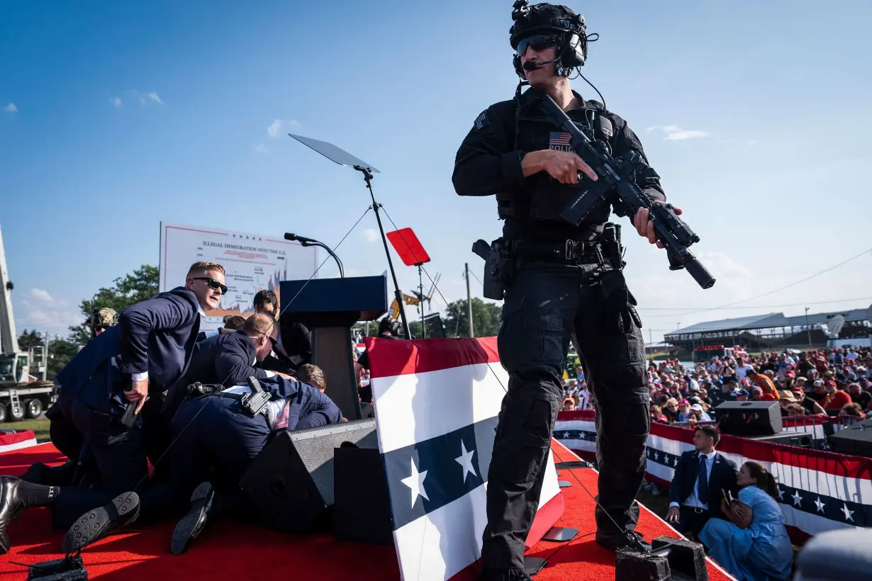 Secret Service agents and counter assault team react moments after shots were fired toward former president Donald Trump during a campaign rally in Butler, Pennsylvania, July 13.