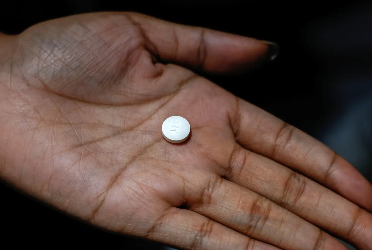 A patient prepares to take Mifepristone, the first medication in a medical abortion, at Alamo Women's Clinic in Carbondale