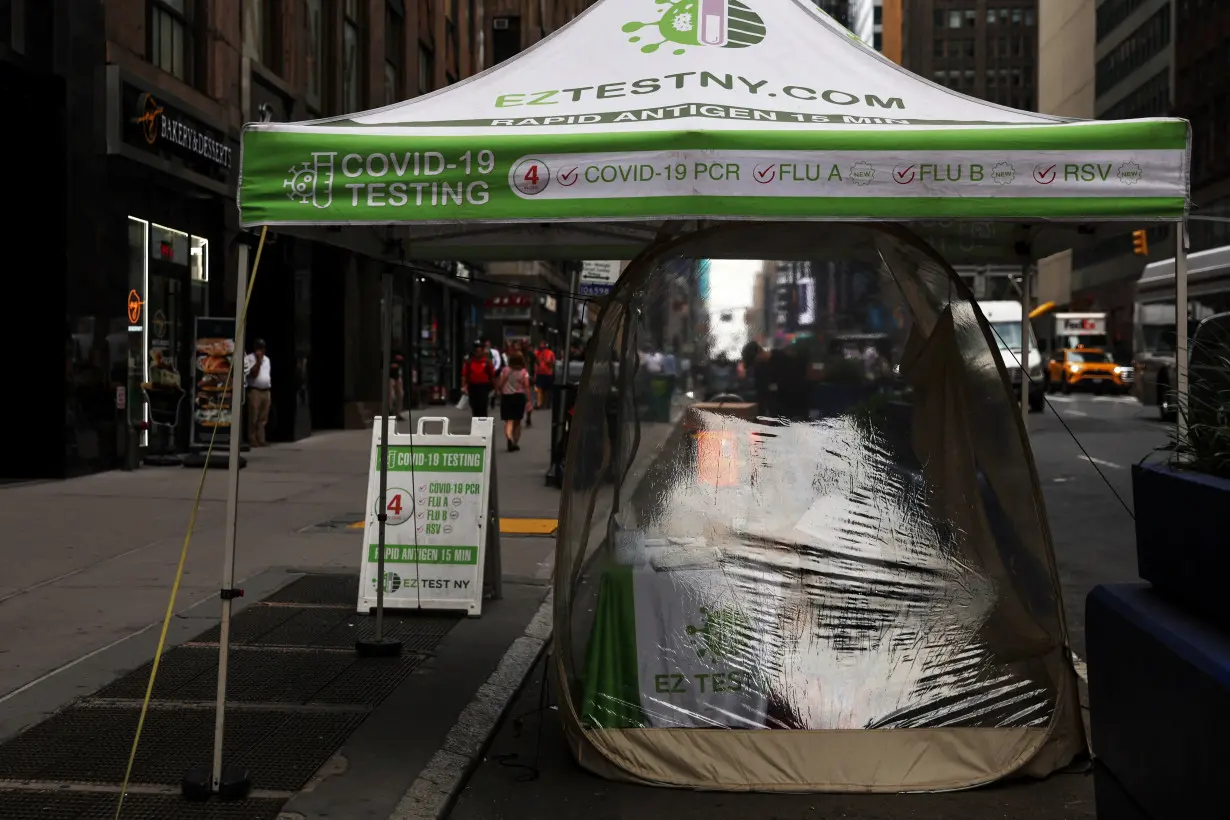 A woman works inside a mobile coronavirus disease (COVID-19) testing center in the Midtown area of New York