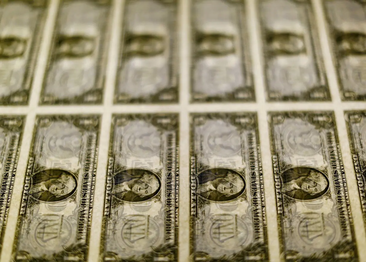 FILE PHOTO: U.S. dollar bills are seen on a light table at the Bureau of Engraving and Printing in Washington