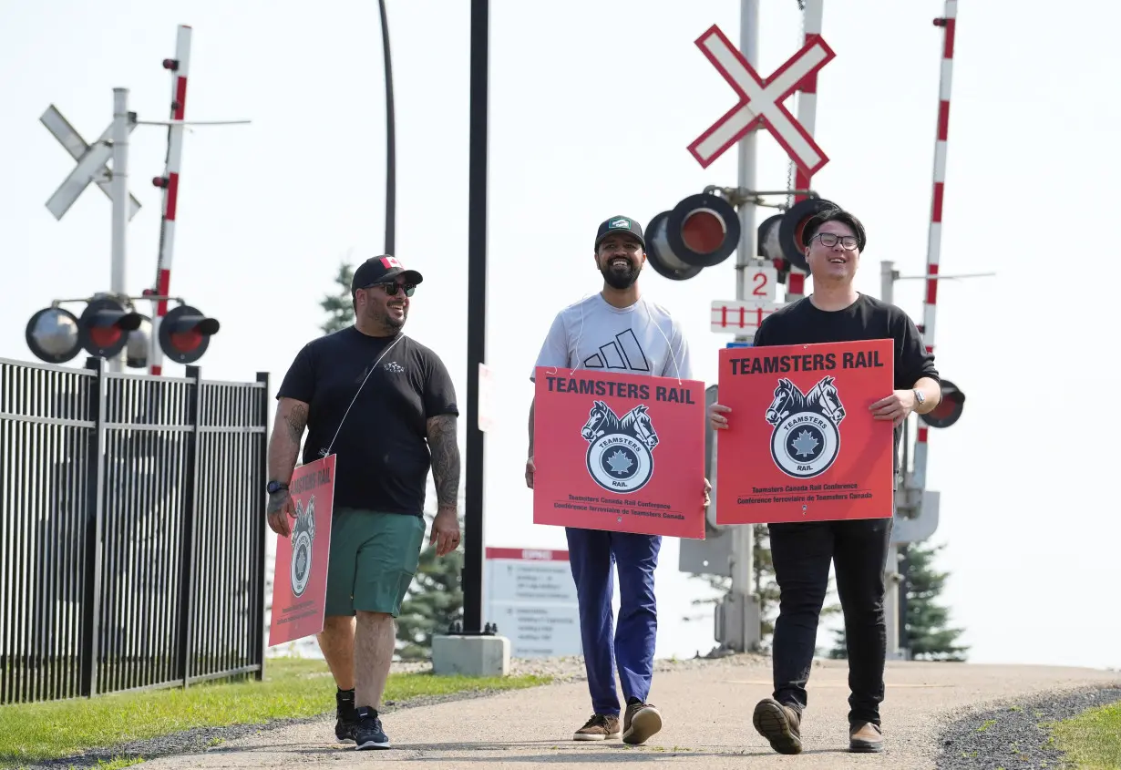 Teamsters union workers picket Canadian Pacific Kansas City (CPKC) headquarters after being locked out by the company in Calgary